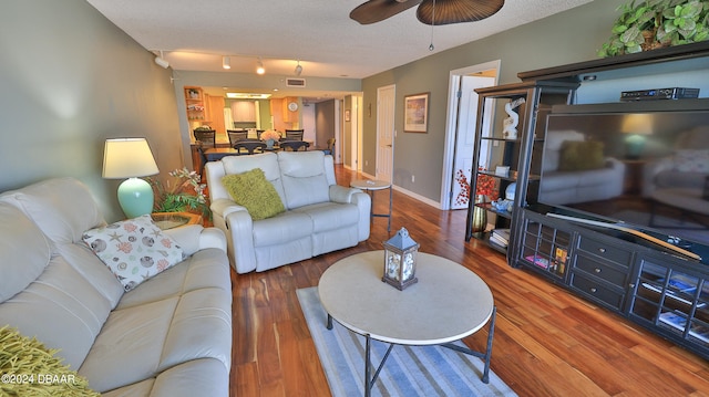 living room featuring hardwood / wood-style flooring, ceiling fan, a textured ceiling, and track lighting