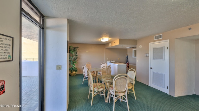 dining room with a textured ceiling and carpet floors