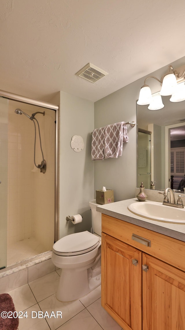 bathroom with walk in shower, vanity, toilet, and tile patterned flooring