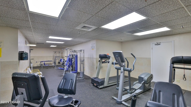 exercise room featuring a paneled ceiling