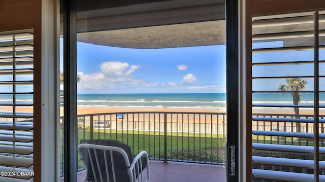 balcony featuring a beach view and a water view