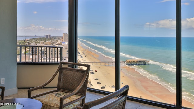 balcony with a beach view and a water view