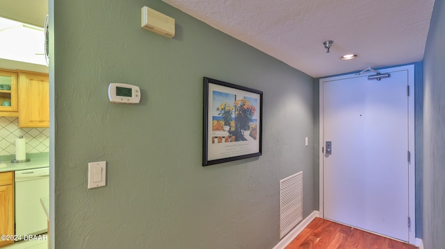 interior space featuring a textured ceiling and dark hardwood / wood-style floors