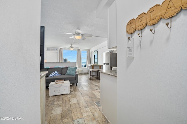 800 N Atlantic Ave Unit 523, Daytona Beach, FL 32118 - living area featuring light wood finished floors, ceiling fan, and a textured ceiling