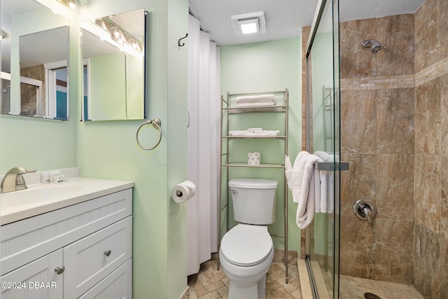 800 N Atlantic Ave Unit 523, Daytona Beach, FL 32118 - full bathroom featuring a stall shower, toilet, vanity, and a textured ceiling