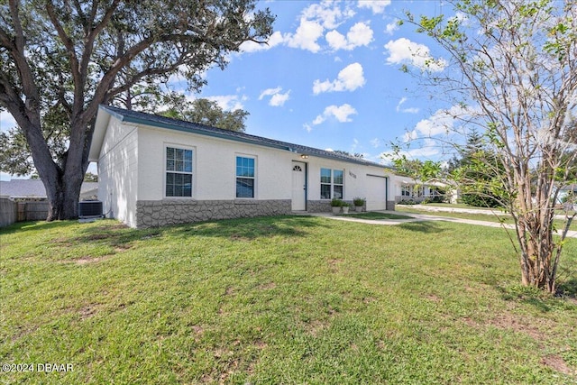 ranch-style house with cooling unit and a front yard