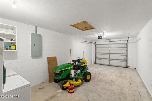 garage featuring a garage door opener, electric panel, and washing machine and dryer