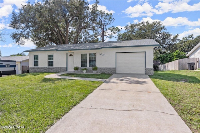 ranch-style home with a front yard and a garage