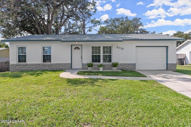 single story home featuring a garage and a front yard