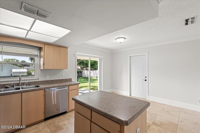 kitchen featuring sink, stainless steel dishwasher, a textured ceiling, and a healthy amount of sunlight