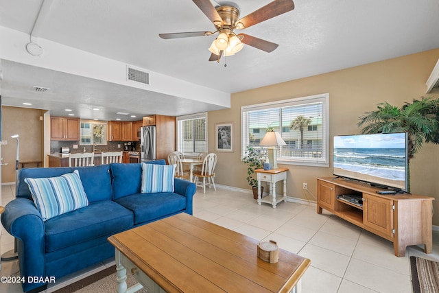 living room with ceiling fan and light tile patterned floors