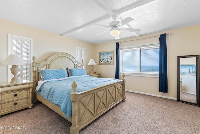 carpeted bedroom featuring a textured ceiling, multiple windows, and ceiling fan