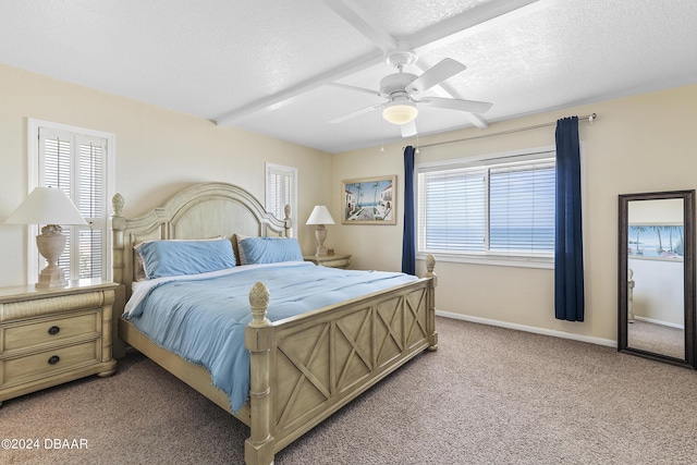 815 Ocean Shore Blvd Unit U1B, Ormond Beach, FL 32176 - bedroom featuring light colored carpet, a textured ceiling, baseboards, and a ceiling fan