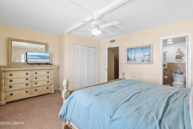 carpeted bedroom with connected bathroom, a closet, a textured ceiling, and ceiling fan