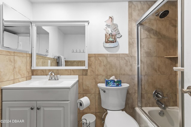 815 Ocean Shore Blvd Unit U1B, Ormond Beach, FL 32176 - bathroom featuring tile walls, toilet, vanity, and bath / shower combo with glass door