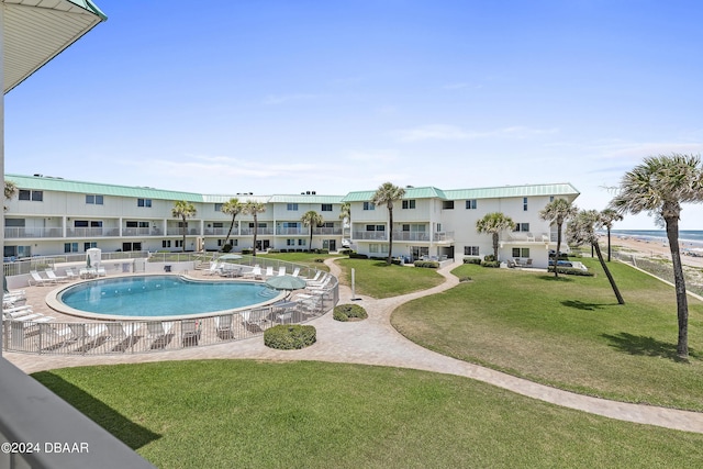 815 Ocean Shore Blvd Unit U1B, Ormond Beach, FL 32176 - community pool with a lawn and a patio