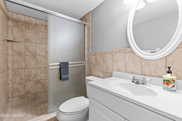 bathroom with tile walls, vanity, a textured ceiling, an enclosed shower, and toilet