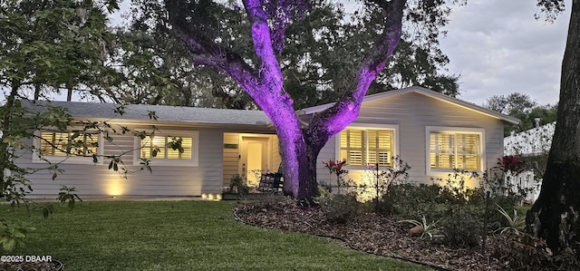 back of house with a lawn