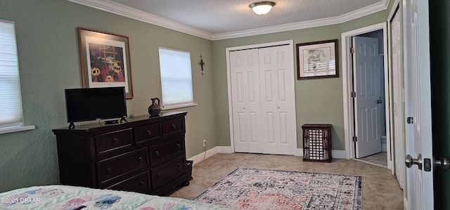 bedroom featuring baseboards, ornamental molding, a closet, a textured ceiling, and a textured wall