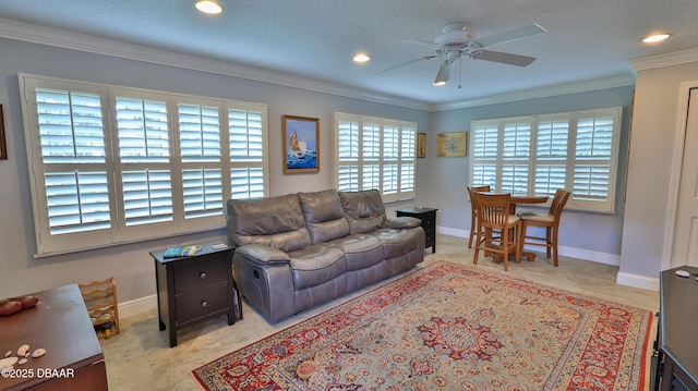 living room featuring a ceiling fan, baseboards, recessed lighting, a textured ceiling, and crown molding