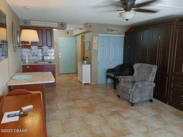 kitchen featuring sink, decorative backsplash, and ceiling fan