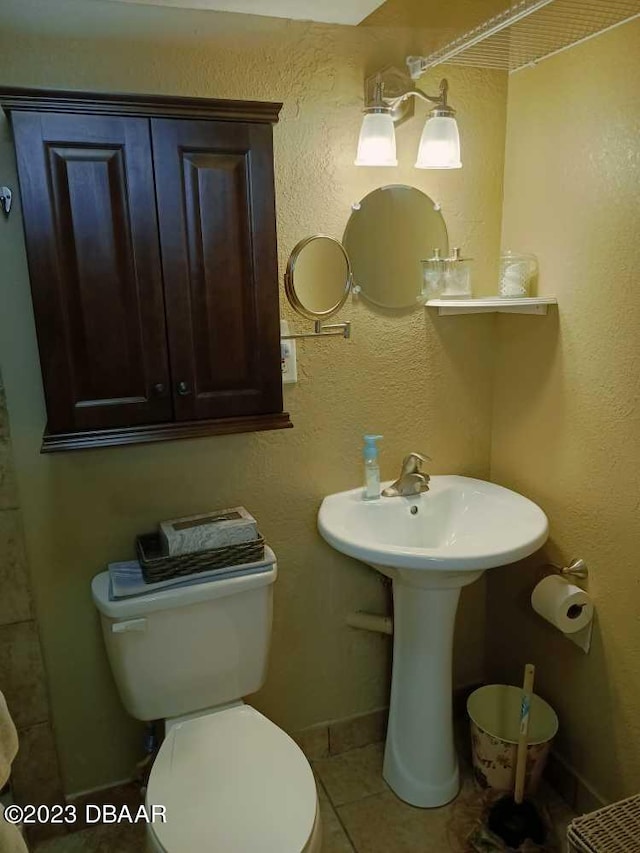 bathroom with tile patterned flooring and toilet