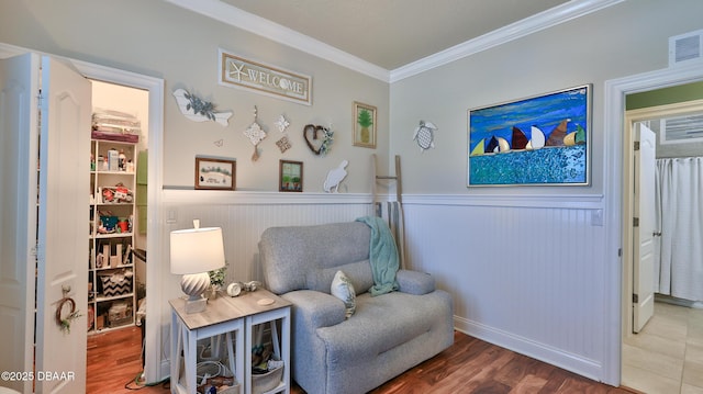 3368 Marsili Ave, New Smyrna Beach, FL 32168 - living area with ornamental molding, wainscoting, and wood finished floors