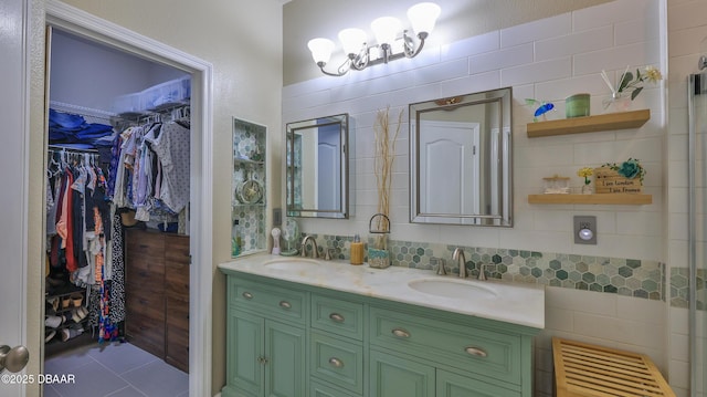 3368 Marsili Ave, New Smyrna Beach, FL 32168 - bathroom featuring double vanity, a spacious closet, a chandelier, and tile patterned floors