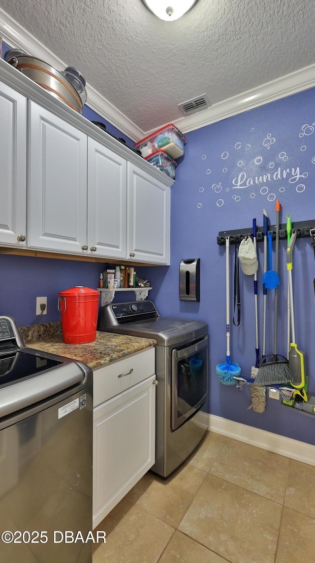 3368 Marsili Ave, New Smyrna Beach, FL 32168 - laundry room featuring washer and clothes dryer, cabinet space, a textured ceiling, light tile patterned floors, and crown molding