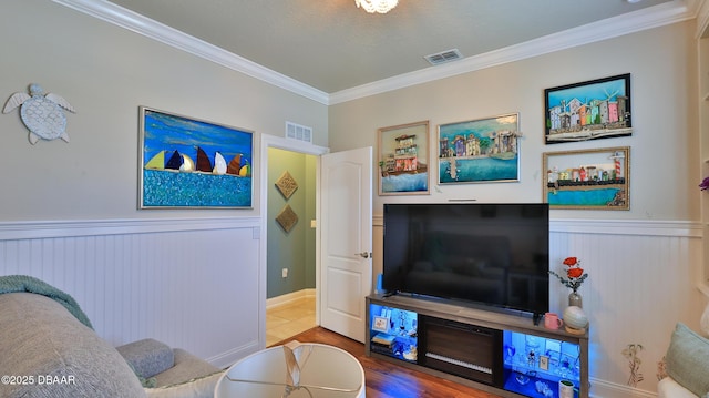 3368 Marsili Ave, New Smyrna Beach, FL 32168 - living area featuring crown molding, wainscoting, and wood finished floors