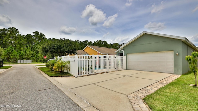 3368 Marsili Ave, New Smyrna Beach, FL 32168 - view of property exterior featuring stucco siding, driveway, and a garage