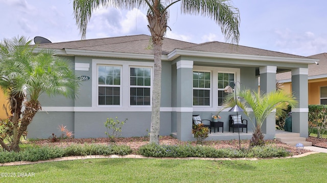 3368 Marsili Ave, New Smyrna Beach, FL 32168 - view of front facade with stucco siding, a front yard, and roof with shingles