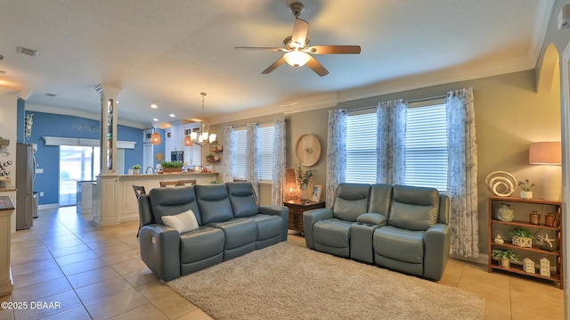 3368 Marsili Ave, New Smyrna Beach, FL 32168 - living area with crown molding, light tile patterned floors, ceiling fan, a chandelier, and decorative columns