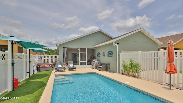 3368 Marsili Ave, New Smyrna Beach, FL 32168 - rear view of property with a sunroom, stucco siding, a fenced backyard, and a patio area