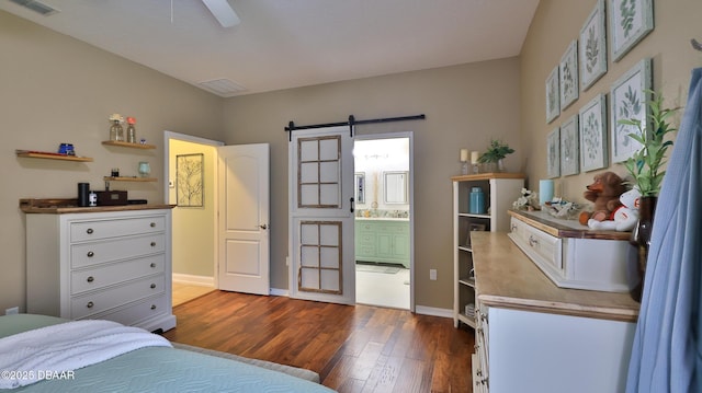 3368 Marsili Ave, New Smyrna Beach, FL 32168 - bedroom featuring a barn door, dark wood-style floors, and ensuite bath