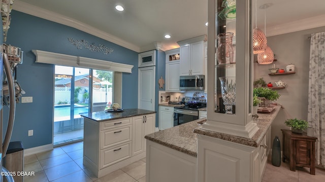 3368 Marsili Ave, New Smyrna Beach, FL 32168 - kitchen with appliances with stainless steel finishes, ornamental molding, a center island, white cabinetry, and stone counters