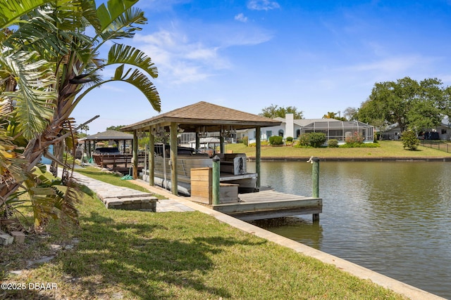 view of dock with boat lift, a lawn, and a water view