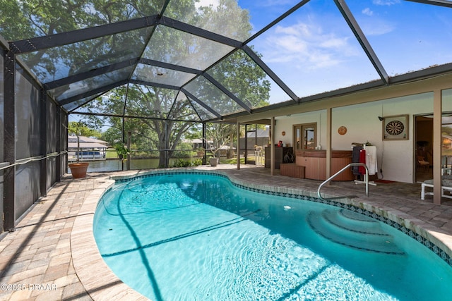 outdoor pool with a lanai and a patio area