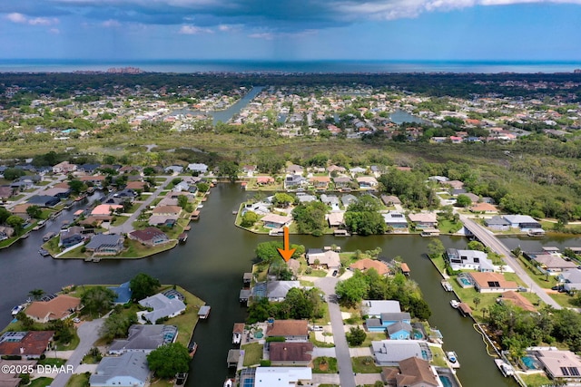 drone / aerial view with a water view and a residential view