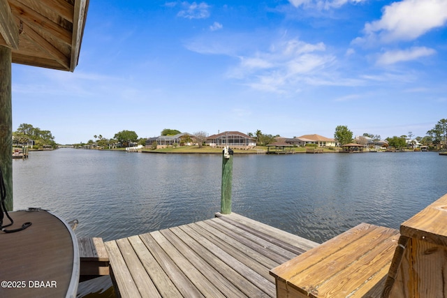 view of dock with a water view and a residential view