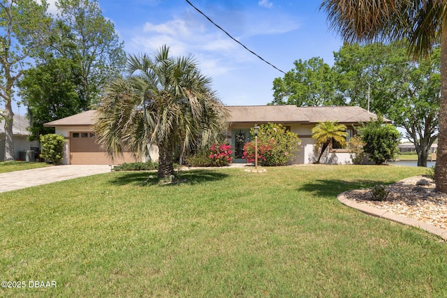 ranch-style home with a front yard, an attached garage, driveway, and stucco siding