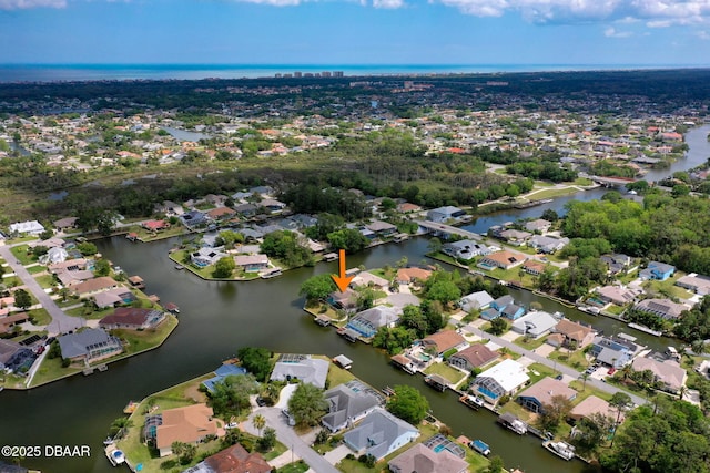 drone / aerial view featuring a water view and a residential view