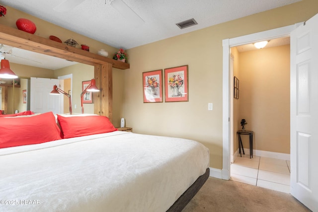 tiled bedroom featuring carpet flooring, visible vents, and baseboards