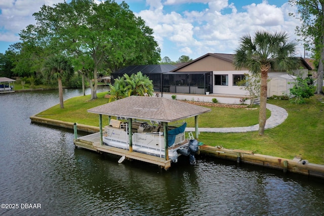 view of dock with a lanai, boat lift, a lawn, and a water view