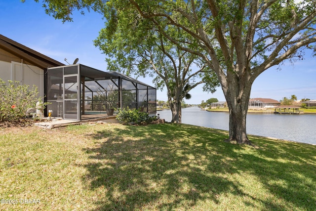 view of yard featuring a water view and glass enclosure