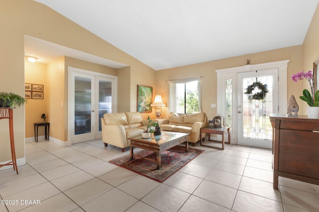 living room featuring french doors, light tile patterned floors, baseboards, and lofted ceiling