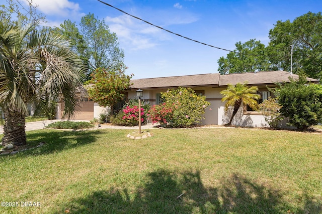 single story home featuring a front lawn, driveway, and stucco siding