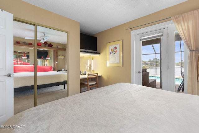 bedroom with carpet floors, access to exterior, and a closet