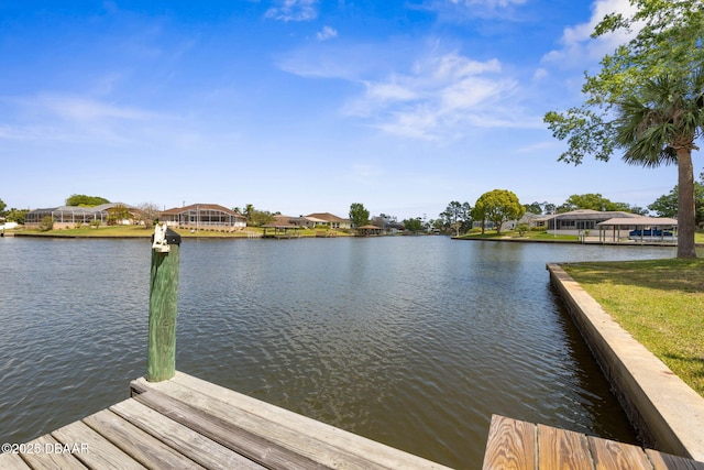 view of dock with a water view and a residential view