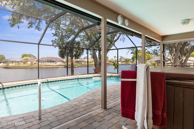 outdoor pool with a patio, a residential view, a water view, and glass enclosure